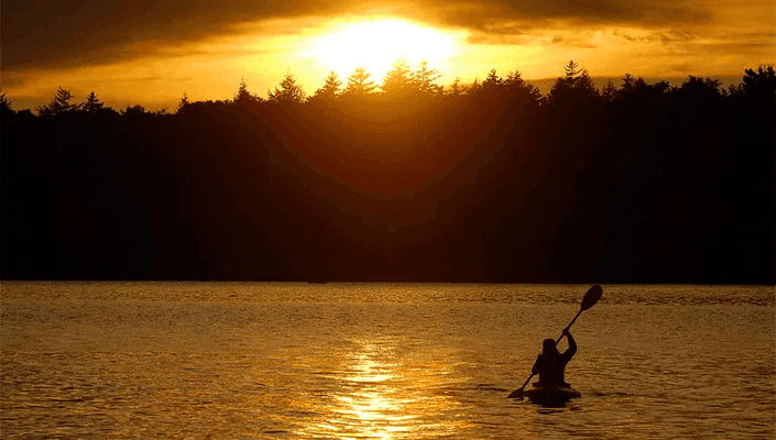 Kayaker with sunset in Boulton Cove.